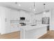 Modern kitchen showcasing stainless appliances, white cabinets, and quartz countertops at 1826 Narrington Ave, North Port, FL 34288