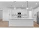 Kitchen island with pendant lighting and white cabinetry at 1826 Narrington Ave, North Port, FL 34288