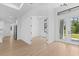 Neutral interior showcasing hardwood floors, open doorway, and abundant natural light at 1826 Narrington Ave, North Port, FL 34288