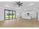 Open concept living area with island, white cabinets, stainless steel appliances, and sliding glass doors at 1826 Narrington Ave, North Port, FL 34288