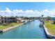 View of canal with docks, boat lift and waterfront homes on a sunny day at 1905 Pennsylvania Ave, Englewood, FL 34224
