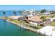 Exterior rear view of canal front home with boat dock on a sunny day at 1905 Pennsylvania Ave, Englewood, FL 34224
