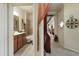 Bathroom view highlighting the fixtures, including vanity, mirror, lighting, and the shower-tub at 20171 Tesoro Dr, Venice, FL 34293