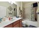 Well-lit bathroom featuring a single sink vanity and shower-tub combo at 20171 Tesoro Dr, Venice, FL 34293