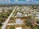 Aerial view shows a single-story home with a very big tree, lots of sunshine, on a large lot, outlined in red at 2033 Georgia Ave, Englewood, FL 34224
