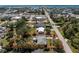 An aerial view showcases a single-story home on a tree-filled lot, close to the ocean and roads, outlined in red at 2033 Georgia Ave, Englewood, FL 34224