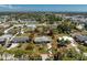 An aerial view showcases the charming single-story home in a lush, green neighborhood near the beach, outlined in red at 2033 Georgia Ave, Englewood, FL 34224
