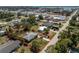 An aerial view displays a single-story home with a lush, green lot, near shops and the ocean, outlined in red at 2033 Georgia Ave, Englewood, FL 34224