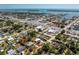 An aerial view of a single-story home on a lush lot, with palm trees near a quiet neighborhood, outlined in red at 2033 Georgia Ave, Englewood, FL 34224