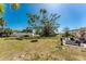 This backyard showcases a large shade tree, green space, and a lounge area at 2033 Georgia Ave, Englewood, FL 34224