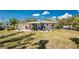 This backyard patio area offers outdoor dining and lounging in a serene setting at 2033 Georgia Ave, Englewood, FL 34224