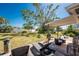 Backyard featuring a covered patio area with comfortable seating and a large tree providing shade at 2033 Georgia Ave, Englewood, FL 34224