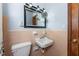 Functional bathroom with tiled walls, sink, and toilet, perfect for everyday convenience at 2033 Georgia Ave, Englewood, FL 34224