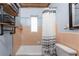 Cozy bathroom with tiled walls, vintage tub, and industrial-style towel rack at 2033 Georgia Ave, Englewood, FL 34224
