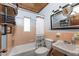 Vintage bathroom with salmon tile, modern fixtures, and industrial-style shelving at 2033 Georgia Ave, Englewood, FL 34224