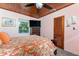 Bedroom featuring wood ceiling, tropical bedding, window views, and ample storage at 2033 Georgia Ave, Englewood, FL 34224