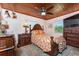 Comfortable bedroom with wood ceiling, tropical bedding, and warm, inviting tones at 2033 Georgia Ave, Englewood, FL 34224