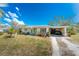 Cozy home with lush green lawn and landscaping, complemented by a carport at 2033 Georgia Ave, Englewood, FL 34224
