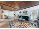 Spacious living room featuring wood ceilings, plenty of natural light, and stylish furnishings at 2033 Georgia Ave, Englewood, FL 34224