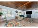 Inviting living room with wood ceilings, large windows, and a comfortable seating area at 2033 Georgia Ave, Englewood, FL 34224