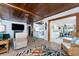 Open living room with a wood ceiling and access to the kitchen and lanai at 2033 Georgia Ave, Englewood, FL 34224