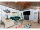 Bright living room featuring wood ceiling, colorful rug, comfortable seating, and a large television at 2033 Georgia Ave, Englewood, FL 34224