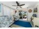Bright sunroom featuring comfortable seating, coastal decor, and sliding glass doors to a patio at 2033 Georgia Ave, Englewood, FL 34224