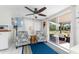 Cozy sunroom with tiled flooring, comfortable seating, ceiling fan, and access to the backyard at 2033 Georgia Ave, Englewood, FL 34224