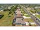 An aerial shot displaying the property's layout, surrounding neighborhood, mature landscaping, and proximity to local amenities at 212 Rotonda E Blvd, Rotonda West, FL 33947