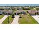 Beautiful single-Gathering home features a three-car garage, manicured lawn, and brick paver driveway at 212 Rotonda E Blvd, Rotonda West, FL 33947