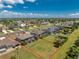 A detailed aerial shot shows a home, its screened pool area, landscaping, and how it fits within the residential neighborhood at 212 Rotonda E Blvd, Rotonda West, FL 33947