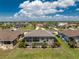 Bird's-eye view of a home with a screened-in pool, lush landscaping, and a peaceful neighborhood setting under a bright sky at 212 Rotonda E Blvd, Rotonda West, FL 33947
