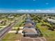 Wide aerial view of a lot with adjacent houses, roads, and lush green landscaping in a well-planned neighborhood at 212 Rotonda E Blvd, Rotonda West, FL 33947
