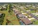 An aerial view of a property showcasing its location, screened in pool and proximity to nearby amenities and lush greenery at 212 Rotonda E Blvd, Rotonda West, FL 33947