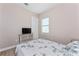 Well-lit bedroom featuring a woven dresser, wood-look flooring and a window at 212 Rotonda E Blvd, Rotonda West, FL 33947