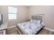 Inviting bedroom with wood-look flooring, white wooden furnishings, and a leafy patterned bedspread at 212 Rotonda E Blvd, Rotonda West, FL 33947