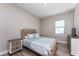 Cozy bedroom with a decorative headboard, wood-look flooring, and light blue accents at 212 Rotonda E Blvd, Rotonda West, FL 33947