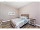 Comfortable bedroom featuring wood-look flooring, woven nightstands, and beach-themed artwork at 212 Rotonda E Blvd, Rotonda West, FL 33947