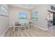 Light and airy dining room with wood-look tile floors and views of the lanai at 212 Rotonda E Blvd, Rotonda West, FL 33947