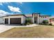 This attractive single-Gathering home boasts a three-car garage, well-kept lawn, and brick paver driveway at 212 Rotonda E Blvd, Rotonda West, FL 33947