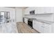 Well-equipped kitchen featuring white cabinetry, stainless steel appliances, and a stylish granite countertop at 212 Rotonda E Blvd, Rotonda West, FL 33947