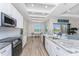 Bright kitchen with granite countertops, stainless steel appliances, and open access to the dining and outdoor areas at 212 Rotonda E Blvd, Rotonda West, FL 33947