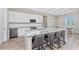 Bright kitchen with a large island, white cabinets, stainless appliances, and a wine cooler at 212 Rotonda E Blvd, Rotonda West, FL 33947