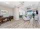 Spacious living room features stylish decor, wood-look flooring, and sliding glass doors to the lanai at 212 Rotonda E Blvd, Rotonda West, FL 33947