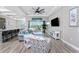 Bright living room boasts stylish furniture, wood-look flooring, and sliding glass doors to the lanai at 212 Rotonda E Blvd, Rotonda West, FL 33947