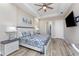Main bedroom with an ensuite bath, tray ceiling, and a view through the ensuite to the shower at 212 Rotonda E Blvd, Rotonda West, FL 33947
