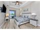 Spacious main bedroom with tray ceiling, a ceiling fan, and access to outdoor space at 212 Rotonda E Blvd, Rotonda West, FL 33947