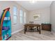 This home office features tile floors, a desk, and a colorful accent piece for storage at 212 Rotonda E Blvd, Rotonda West, FL 33947