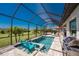 Inviting covered pool and patio with outdoor grill and lounge seating at 212 Rotonda E Blvd, Rotonda West, FL 33947