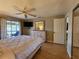 Comfortable bedroom featuring a ceiling fan, tv, sliding glass door to balcony and dresser at 22375 Edgewater Dr # F219, Port Charlotte, FL 33980